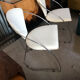 Set of two design chairs in steel and faux leather.