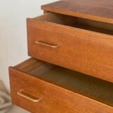 Vintage 1960s chest of drawers with covered handles.