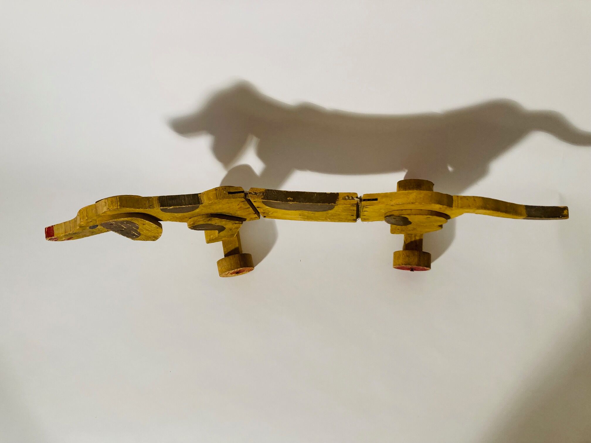 Toy old dog sausage dachshund to drag wooden
