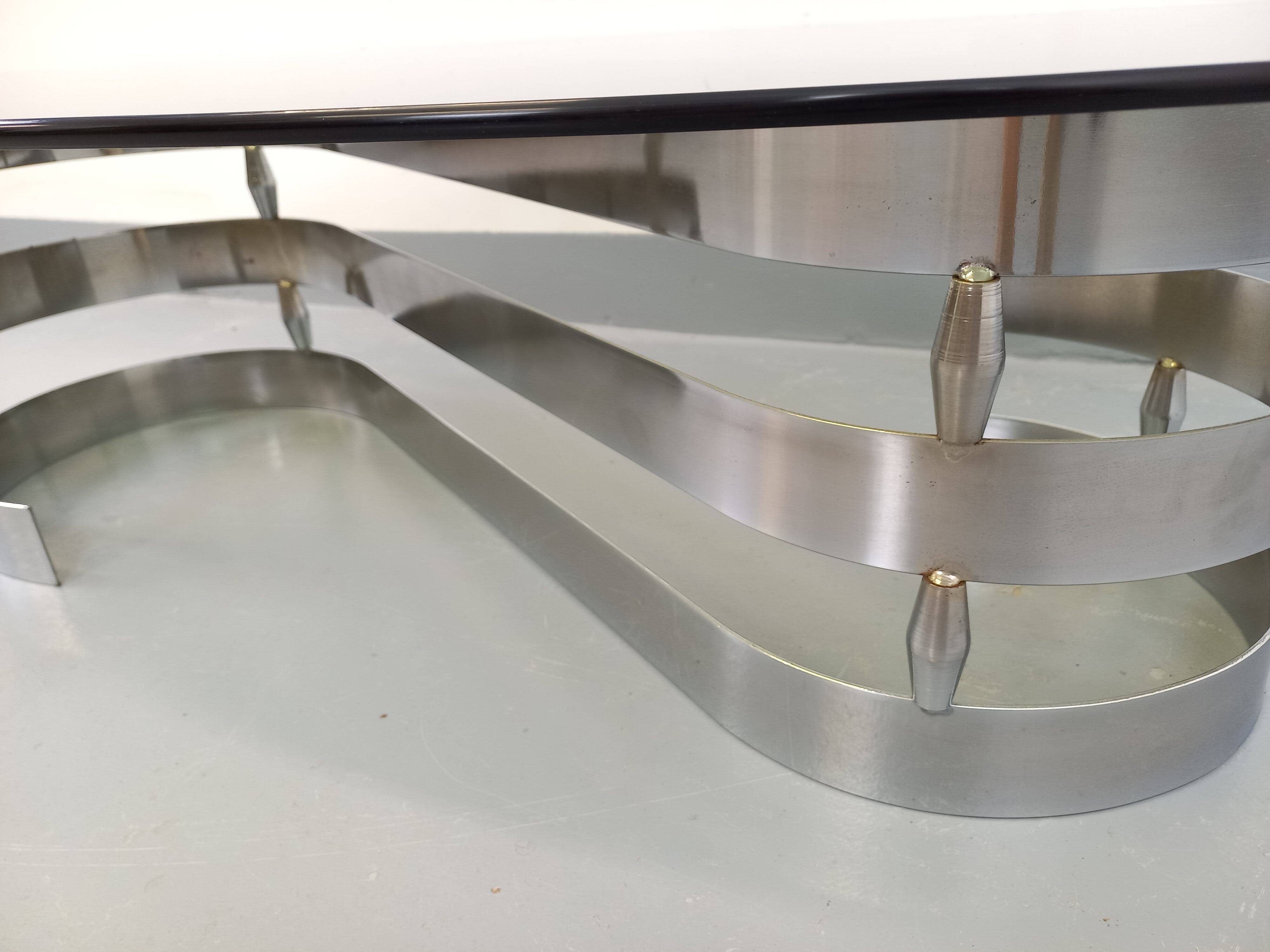 Vintage oval coffee table in smoked glass and chrome metal from the 1970s.