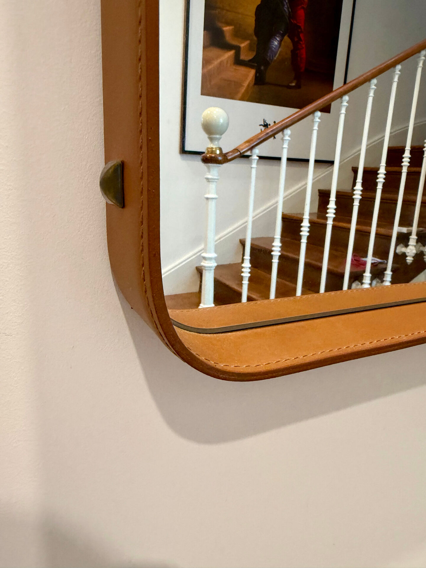 Jacques Adnet mirror covered in cognac leather