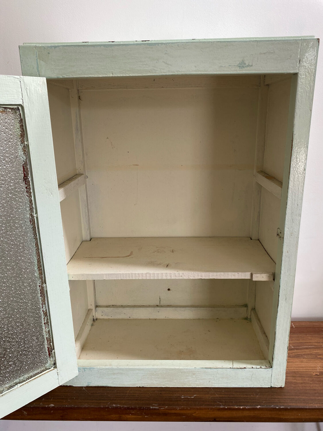 Old medicine cabinet in mint green patinated wood