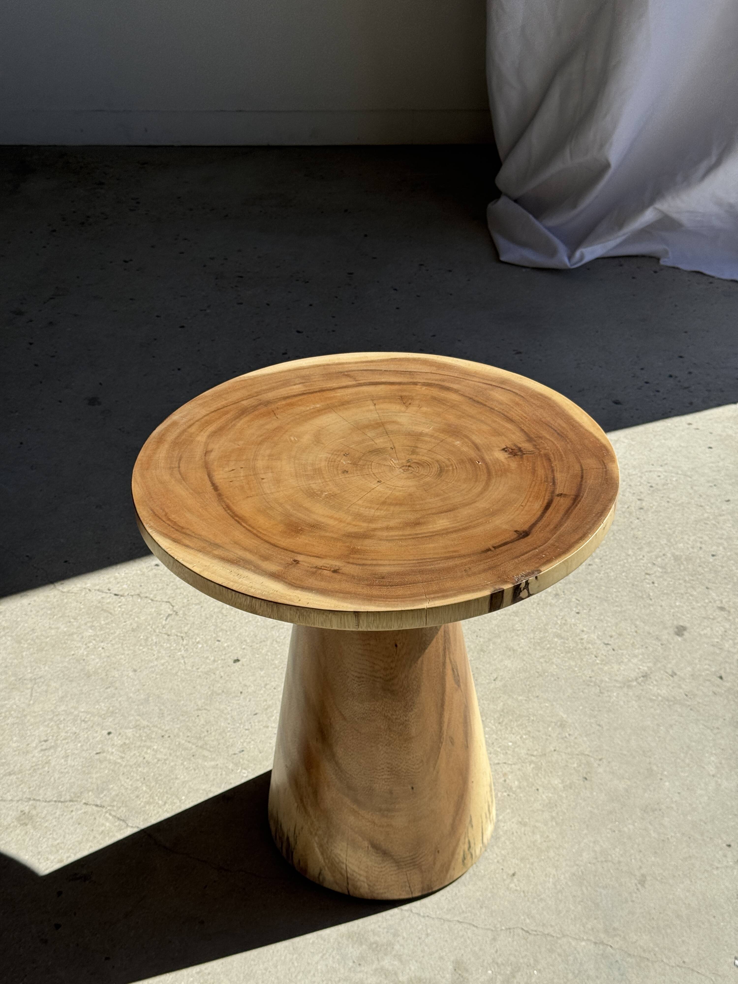 Natural solid suar side table (monoxyle) with a minimal conical base.
