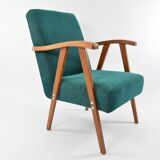 Green curved armchair
