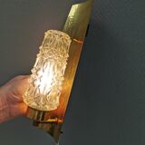 Older wall lamp in brass with hard pressed glass shade.