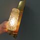 Older wall lamp in brass with hard pressed glass shade.