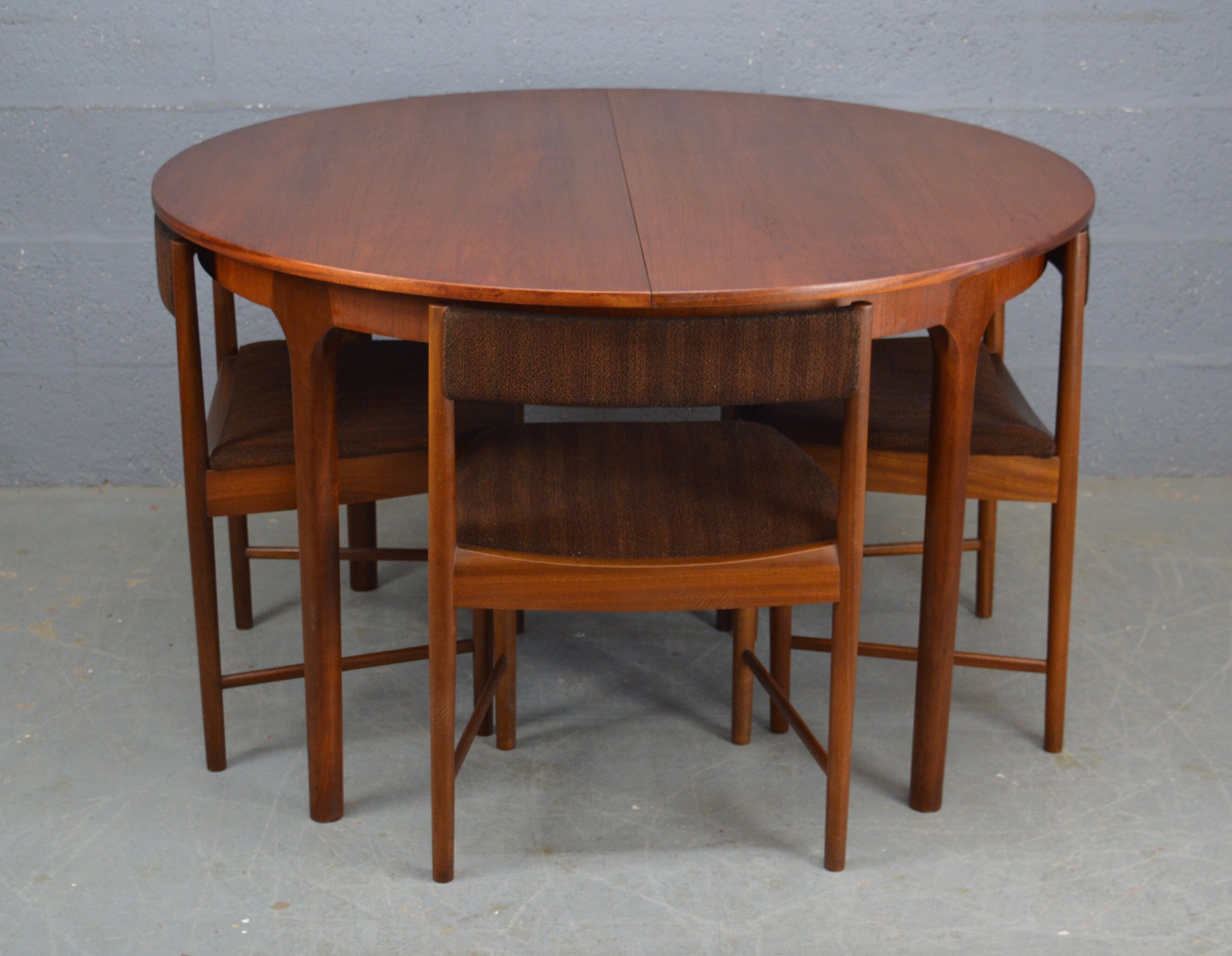 Round teak dinning table and chairs by Mctintosh