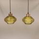 Hanging lamp with an outer shade of olive green glass and an inner shade of clear, crystal glass.