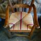 Child's high chair with a rush seat in walnut