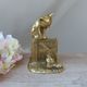 Golden brass cat figurine on fence looking at a mouse in a Vintage India shoe
