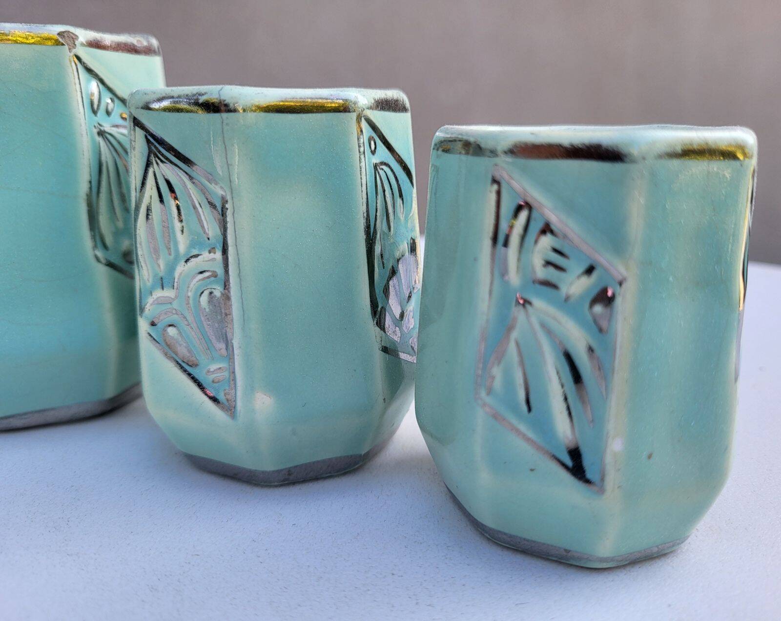 Set of 4 Art Deco celadon green and silver barbotine pots.