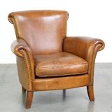 Beautiful and comfortable sheepskin armchair, finished with decorative nailheads