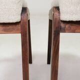 Pair of wooden stools with beige fabric.