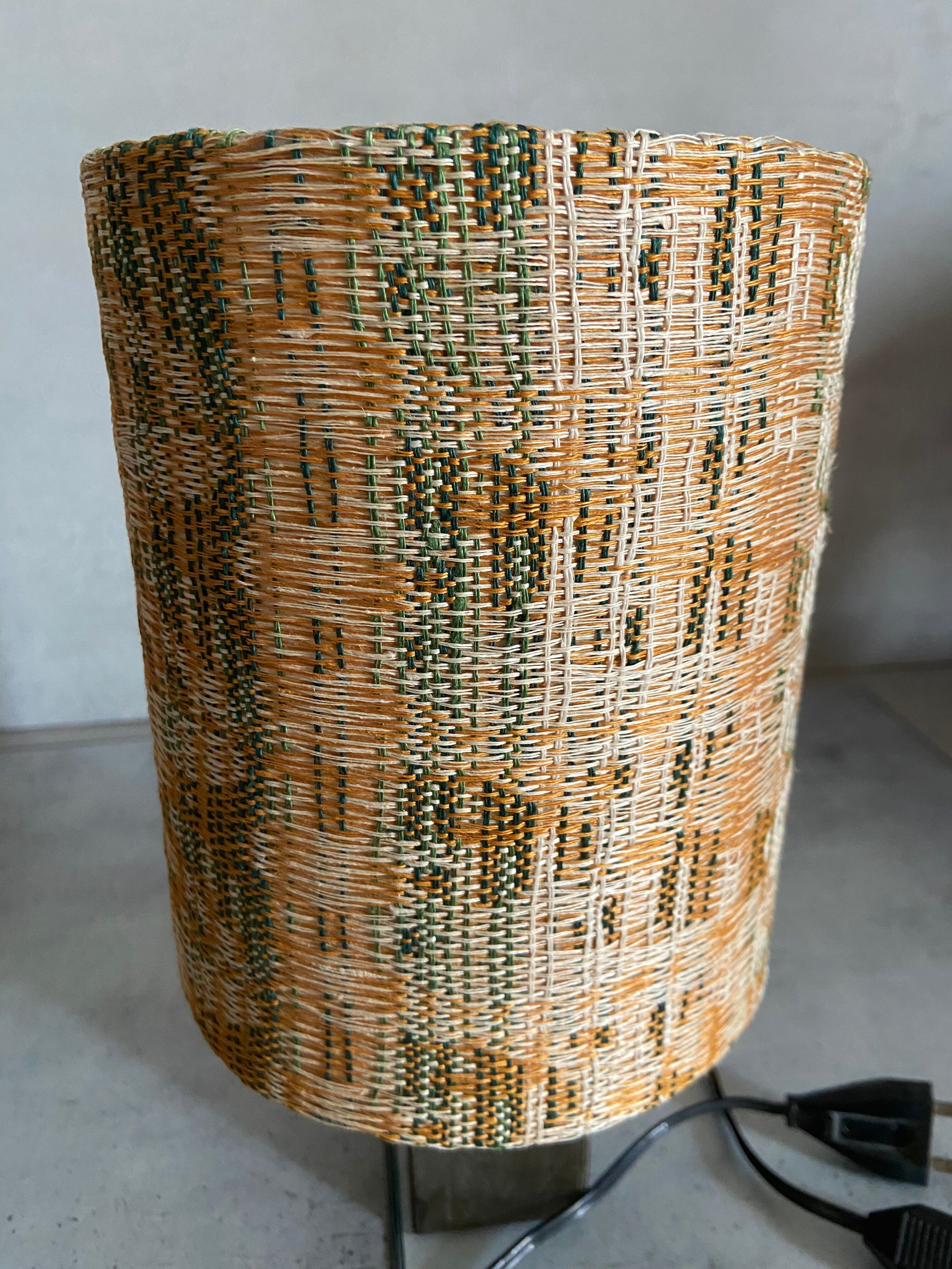 Small modernist table lamp with hand-woven shade.