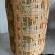 Small modernist table lamp with hand-woven shade.