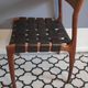chair wooden structure and sitting with braiding of black skai strips