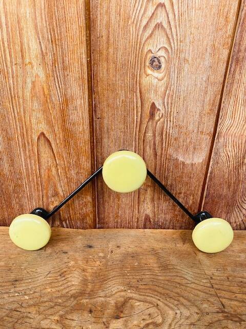 Vintage yellow wall coat rack