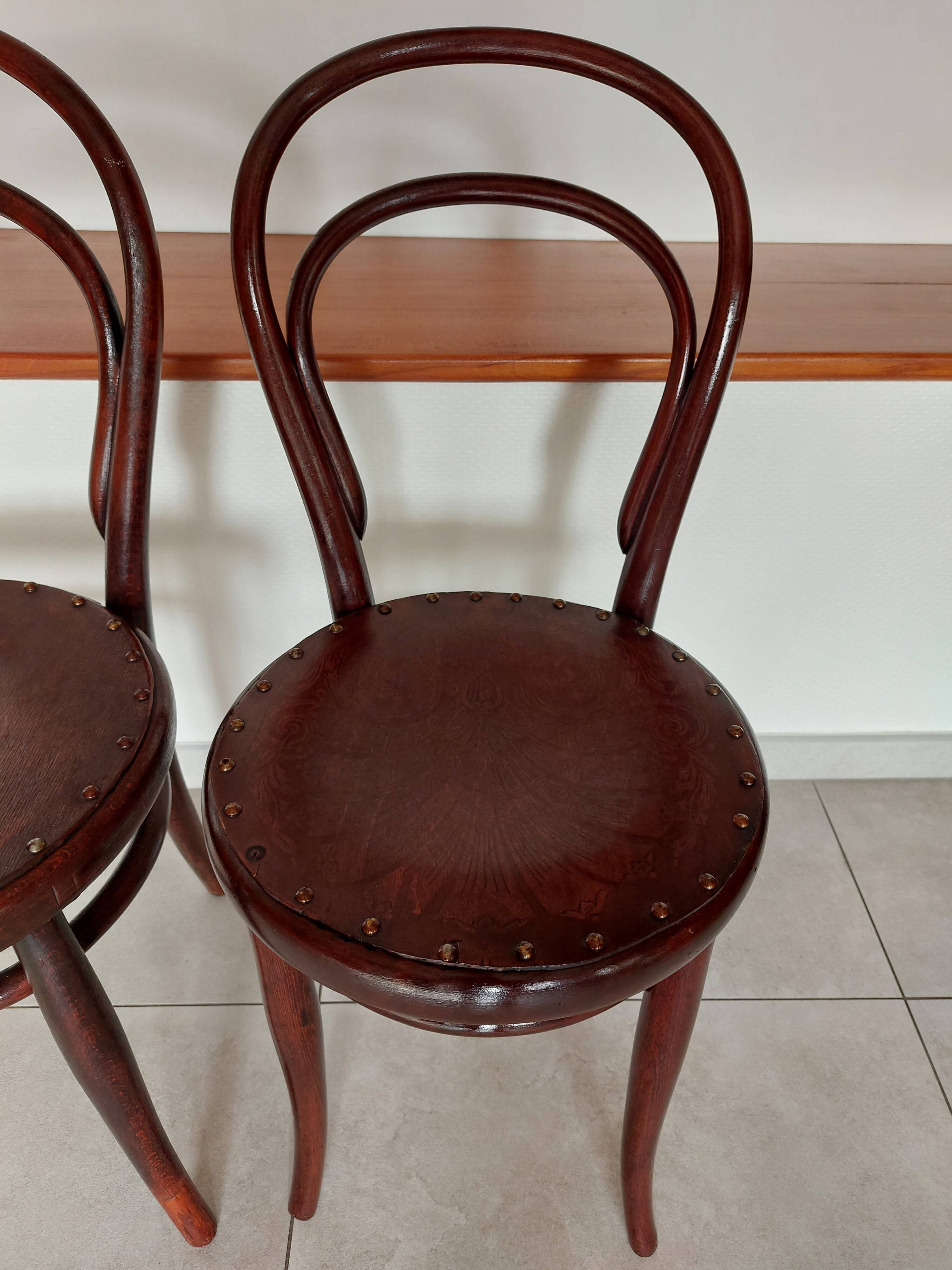 pair of round bistro chairs with a pattern on the seat, vintage