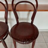 pair of round bistro chairs with a pattern on the seat, vintage