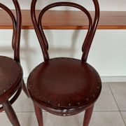 pair of round bistro chairs with a pattern on the seat, vintage