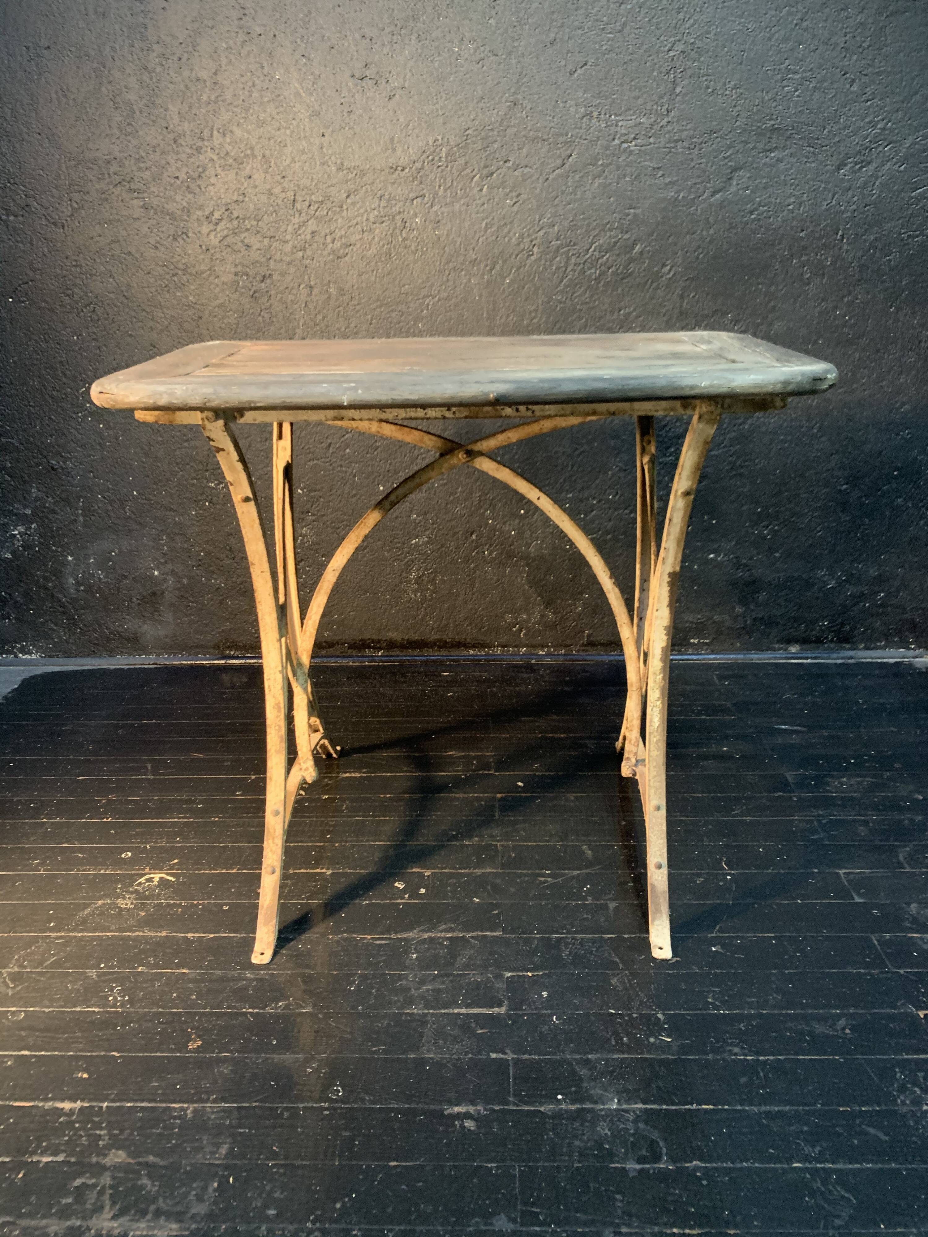 Ancient wrought iron and wood garden table