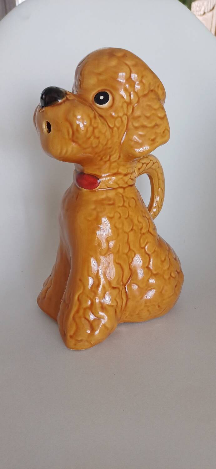 Ancient ceramic pitcher in the shape of a poodle.