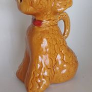 Ancient ceramic pitcher in the shape of a poodle.