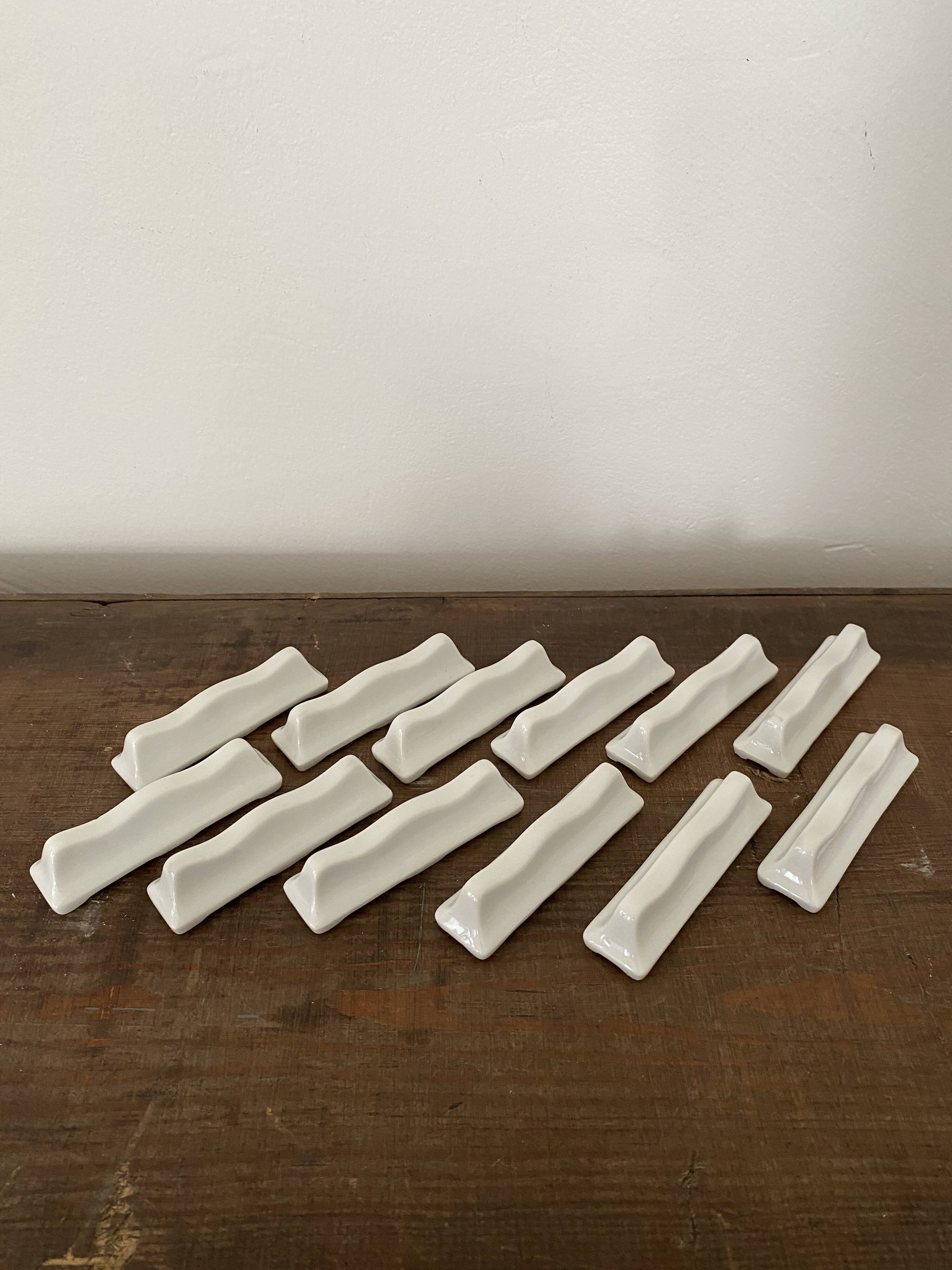 Vintage knife holders of 12, in white wave-shaped porcelain