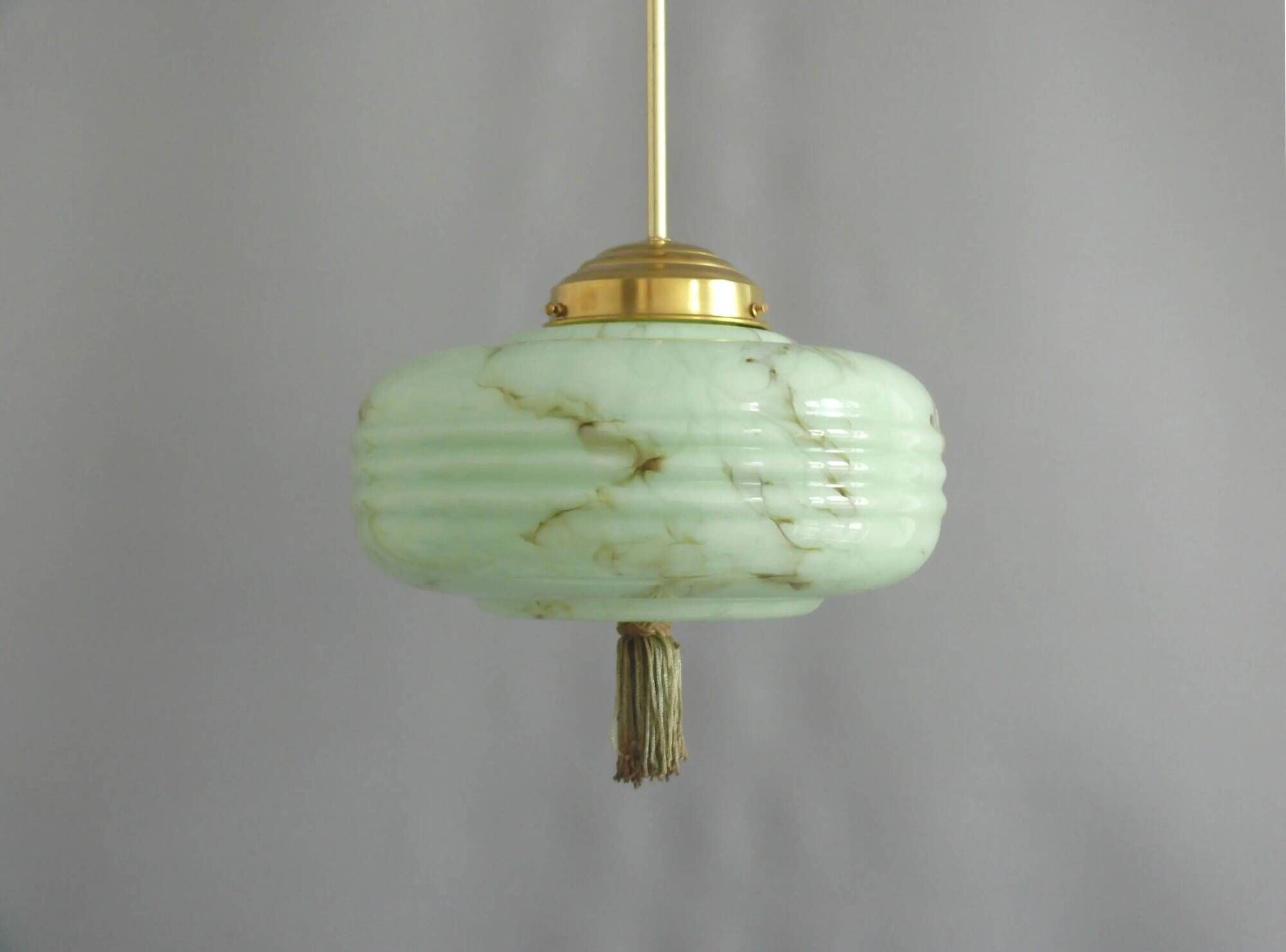 Lampe à pendentif Art Déco avec suspension en laiton et abat-jour en verre marbré.