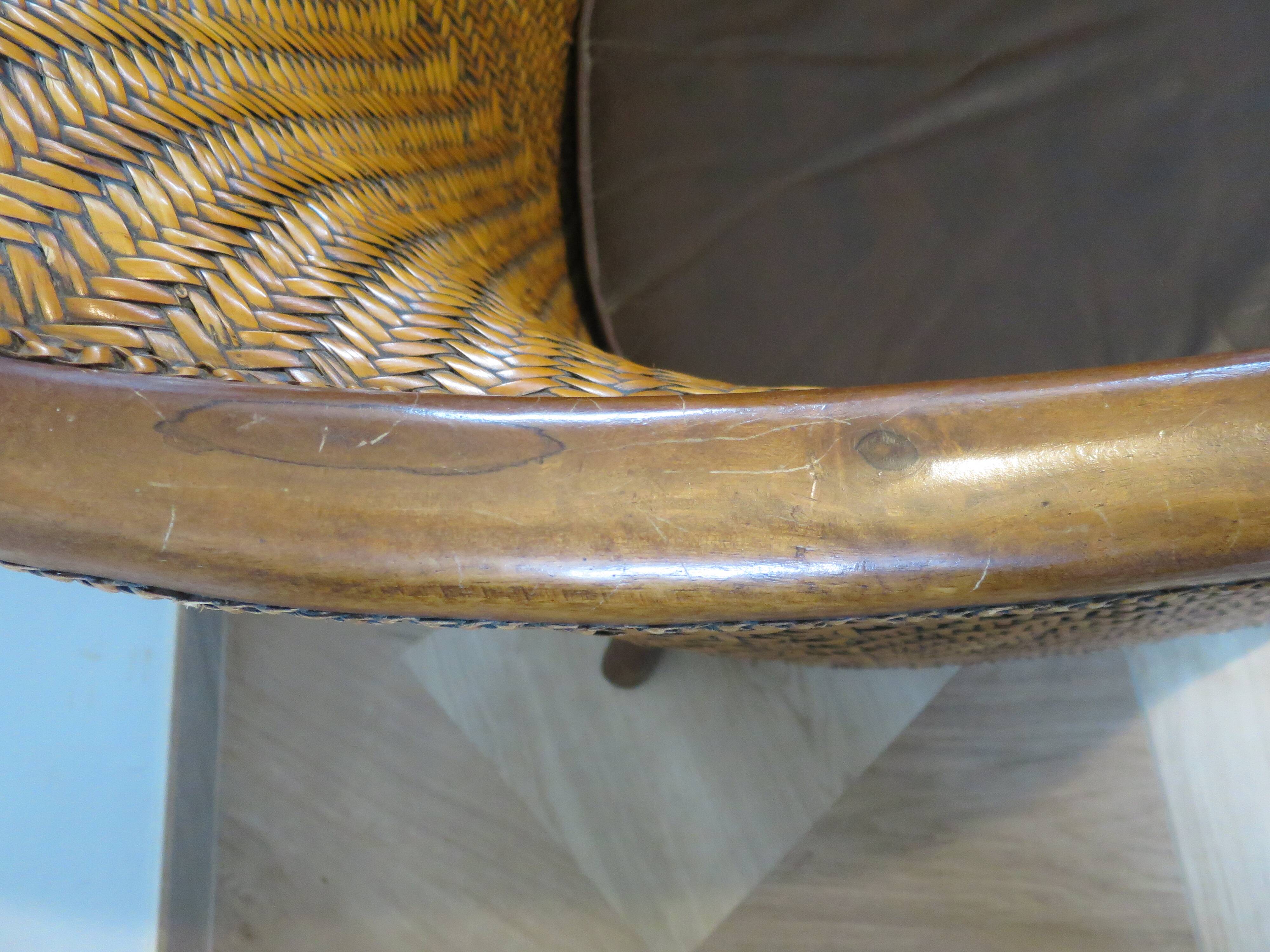 Colonial style armchair in woven rattan and exotic wood