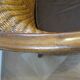 Colonial style armchair in woven rattan and exotic wood