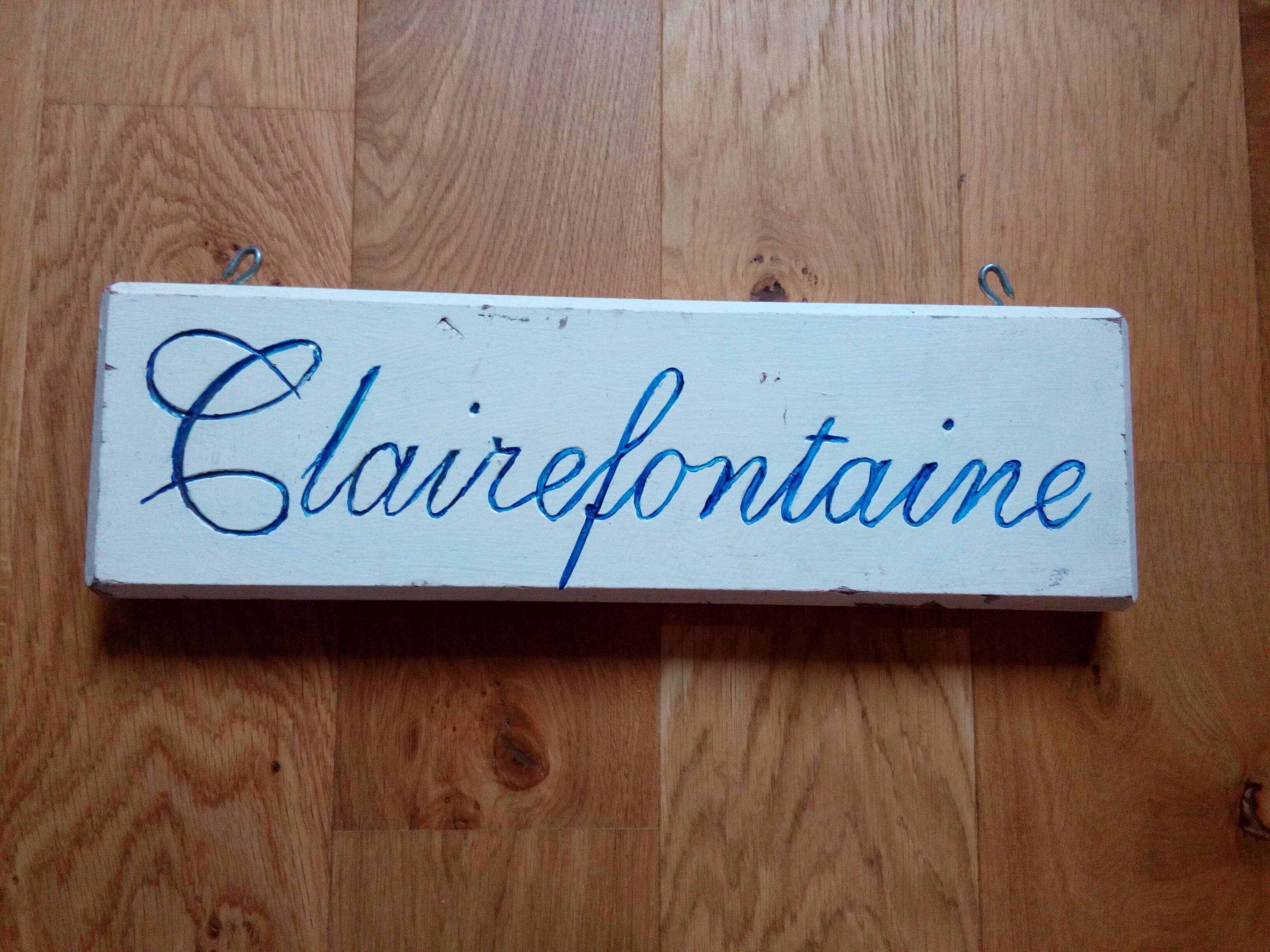 double-sided wooden panel with carved inscription "Clairefontaine"