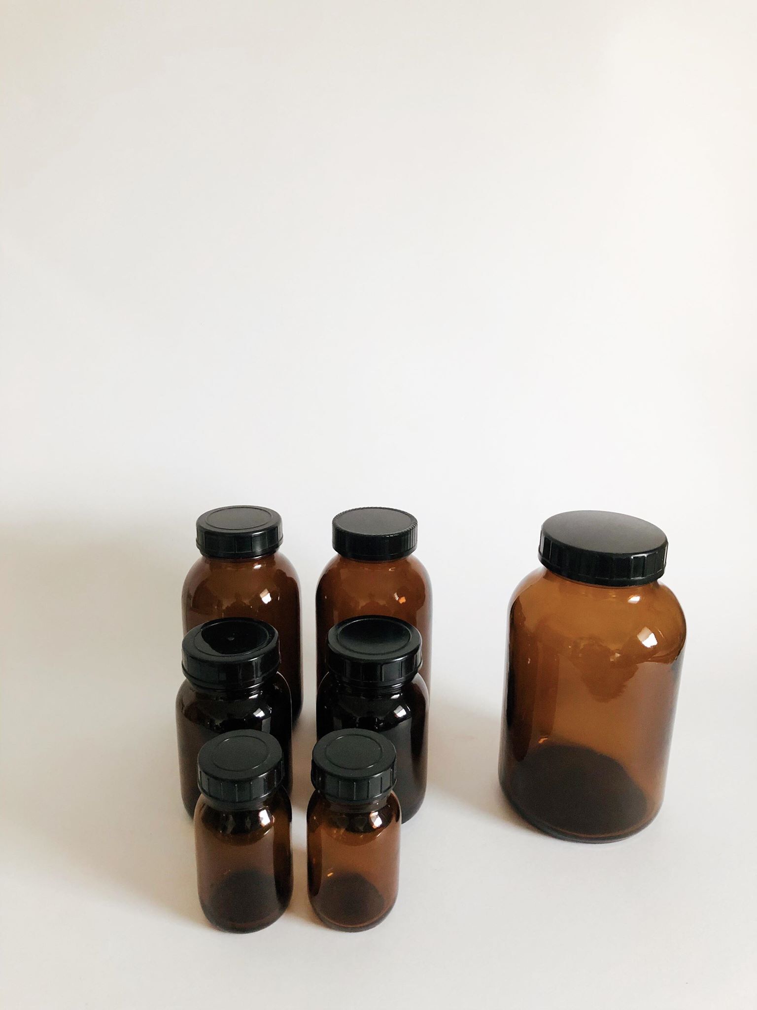 Lot of 7 bottles of amber glass apothecary style