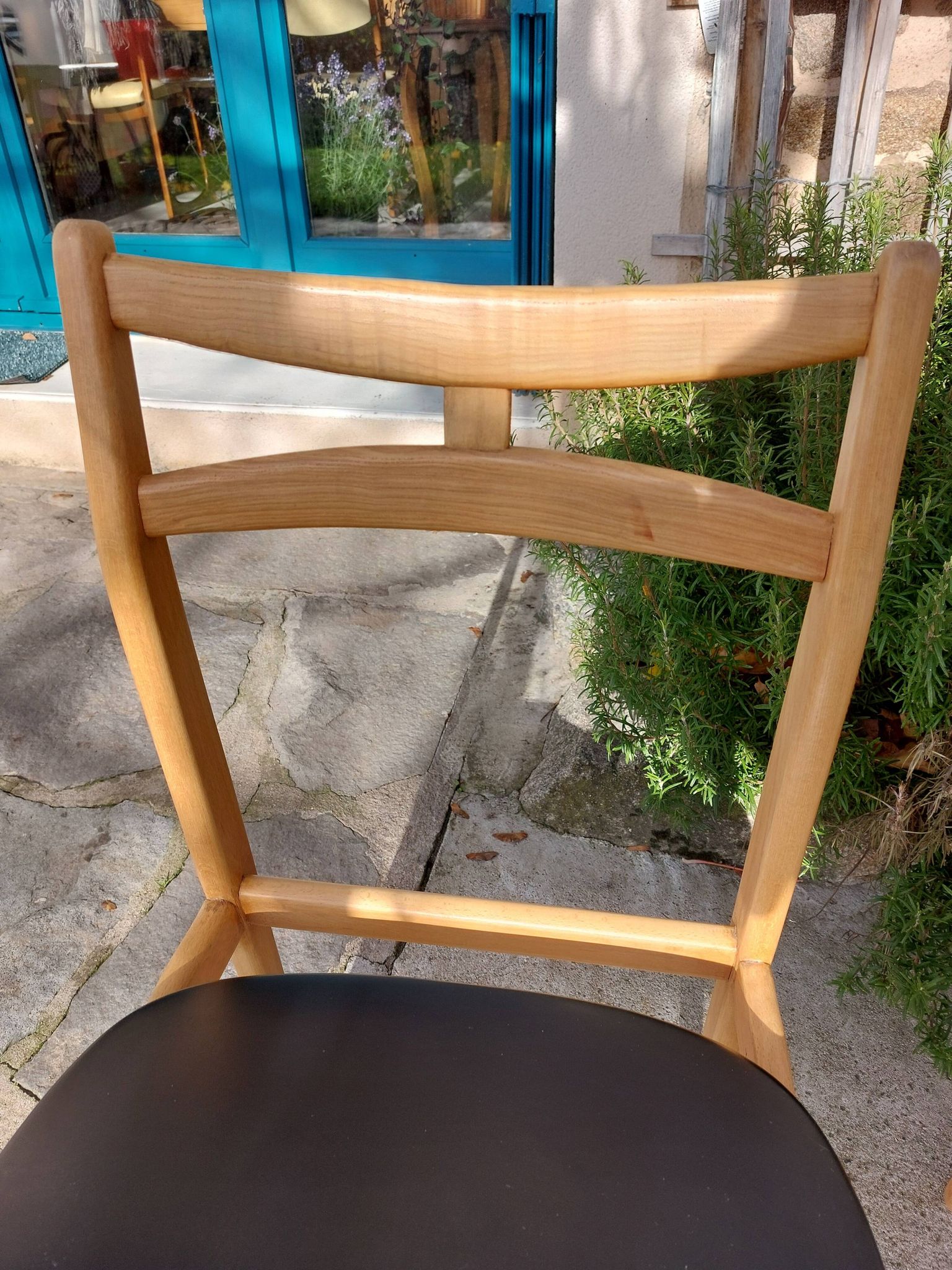 3 Scandinavian style chairs, light wood and black faux leather.