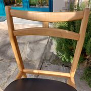 3 Scandinavian style chairs, light wood and black faux leather.