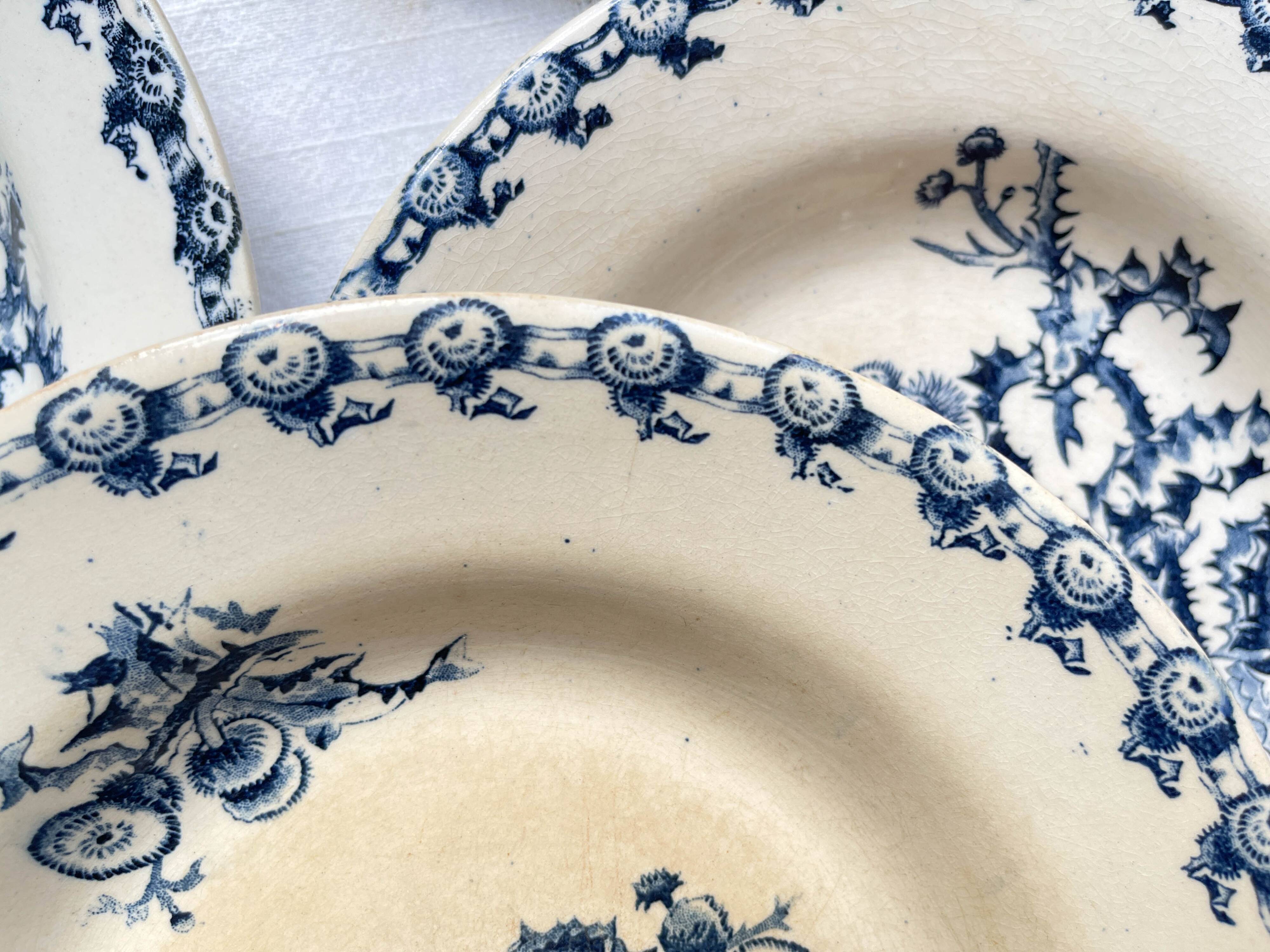 10 mismatched vintage soup plates in blue, green, and red ironstone