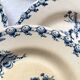 10 mismatched vintage soup plates in blue, green, and red ironstone