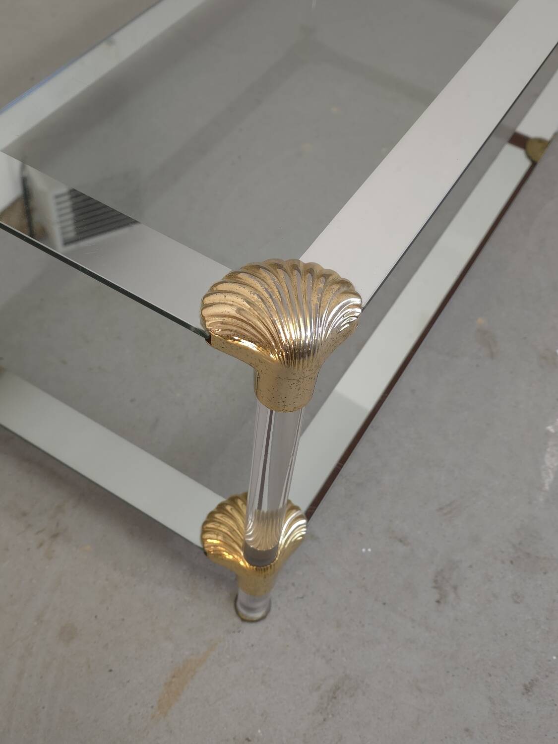 Coffee table, living room table in glass with two tiers, adorned with golden seashells, 1970.