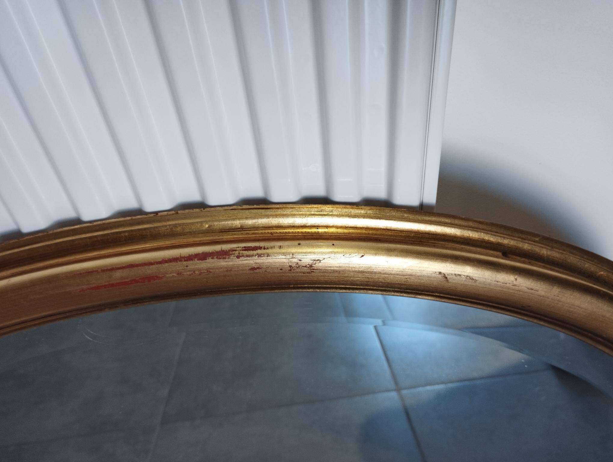 Grand et élégant miroir doré ovale avec sa glace biseauté