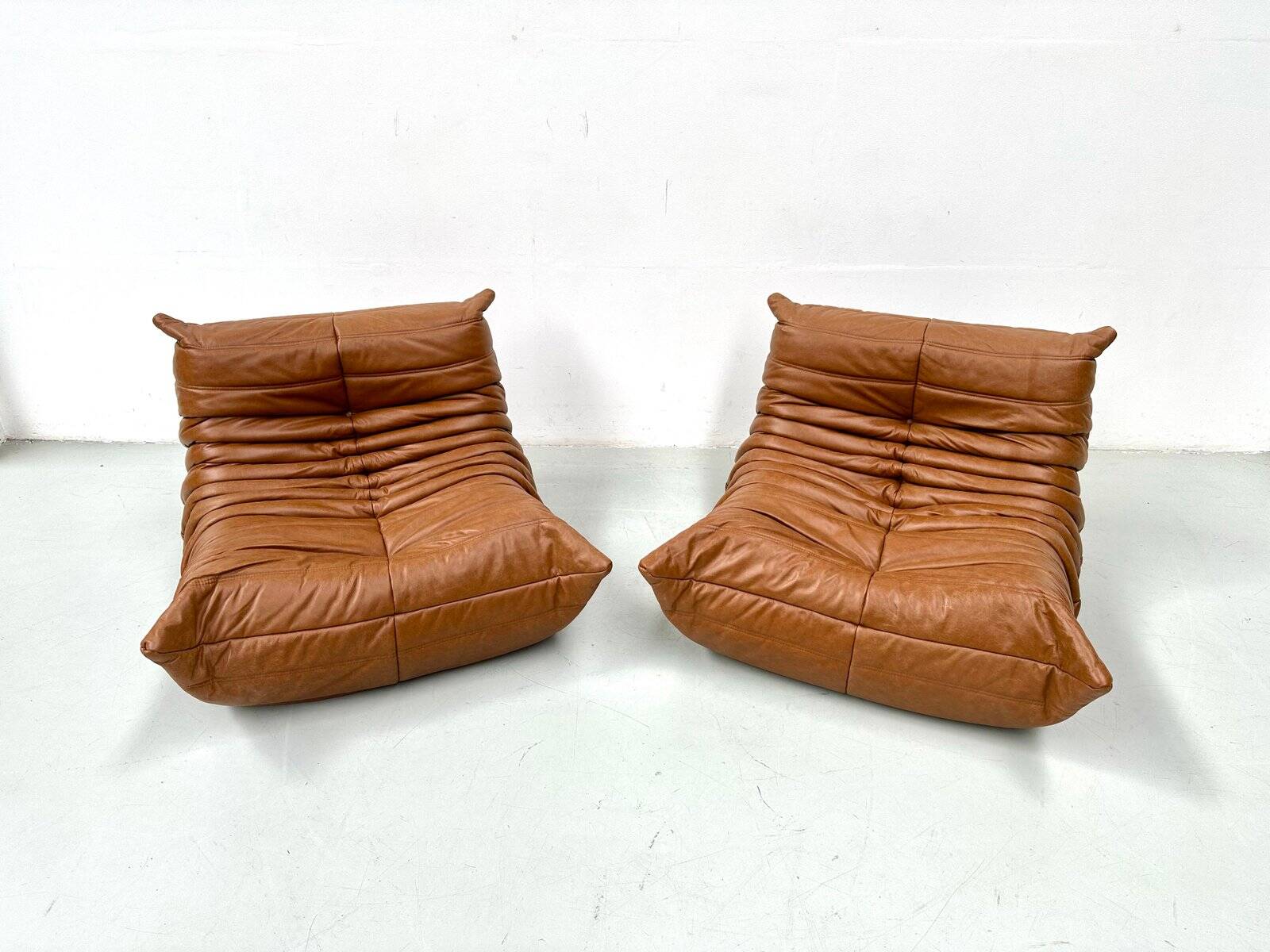 Togo lounge chairs in cognac cow leather attributed to Michel Ducaroy for Ligne Roset, set of 2