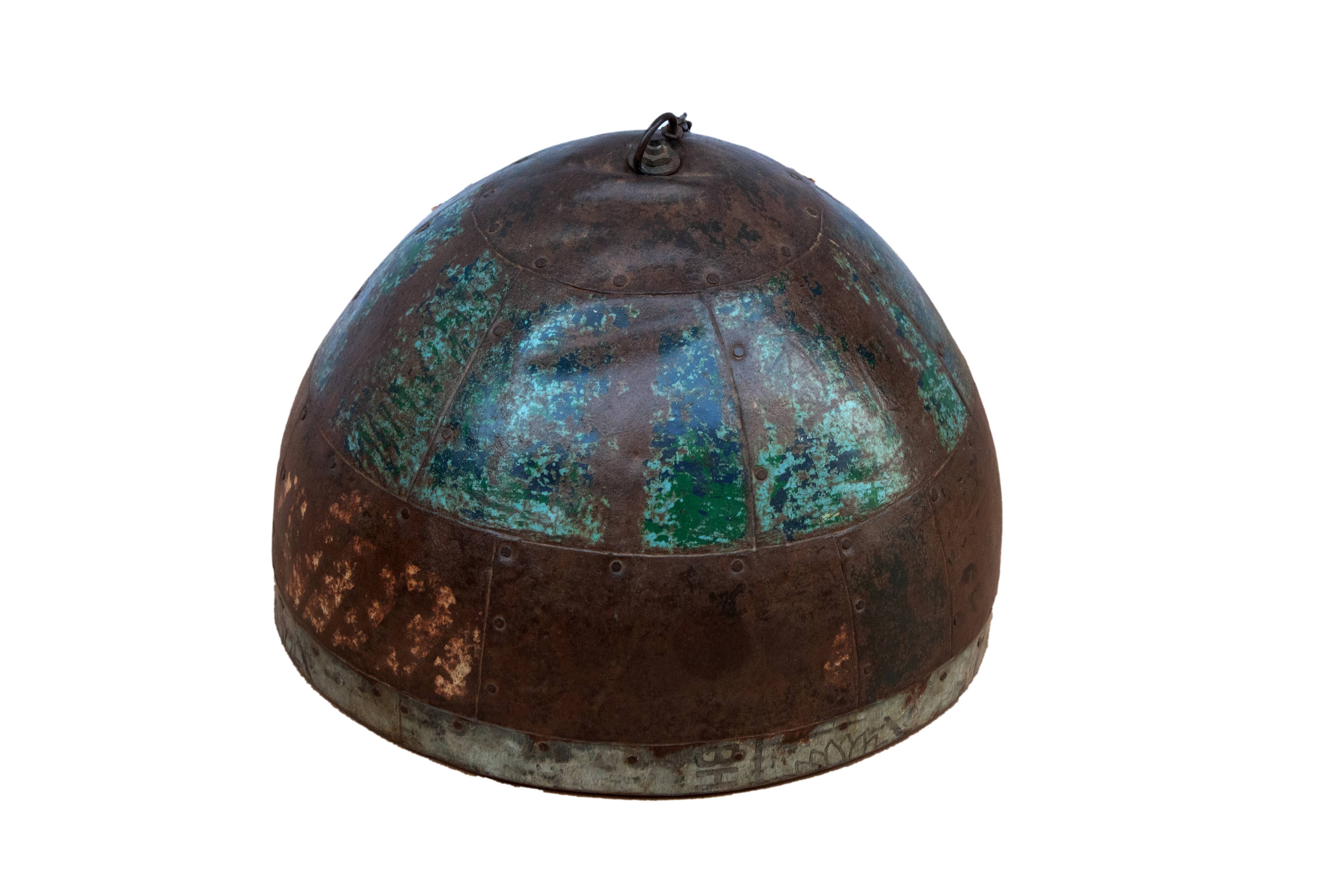 Metal hanging with its original blue-green-rust colour
