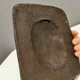 Small relief with a motif of an owl emerging from the back plate.