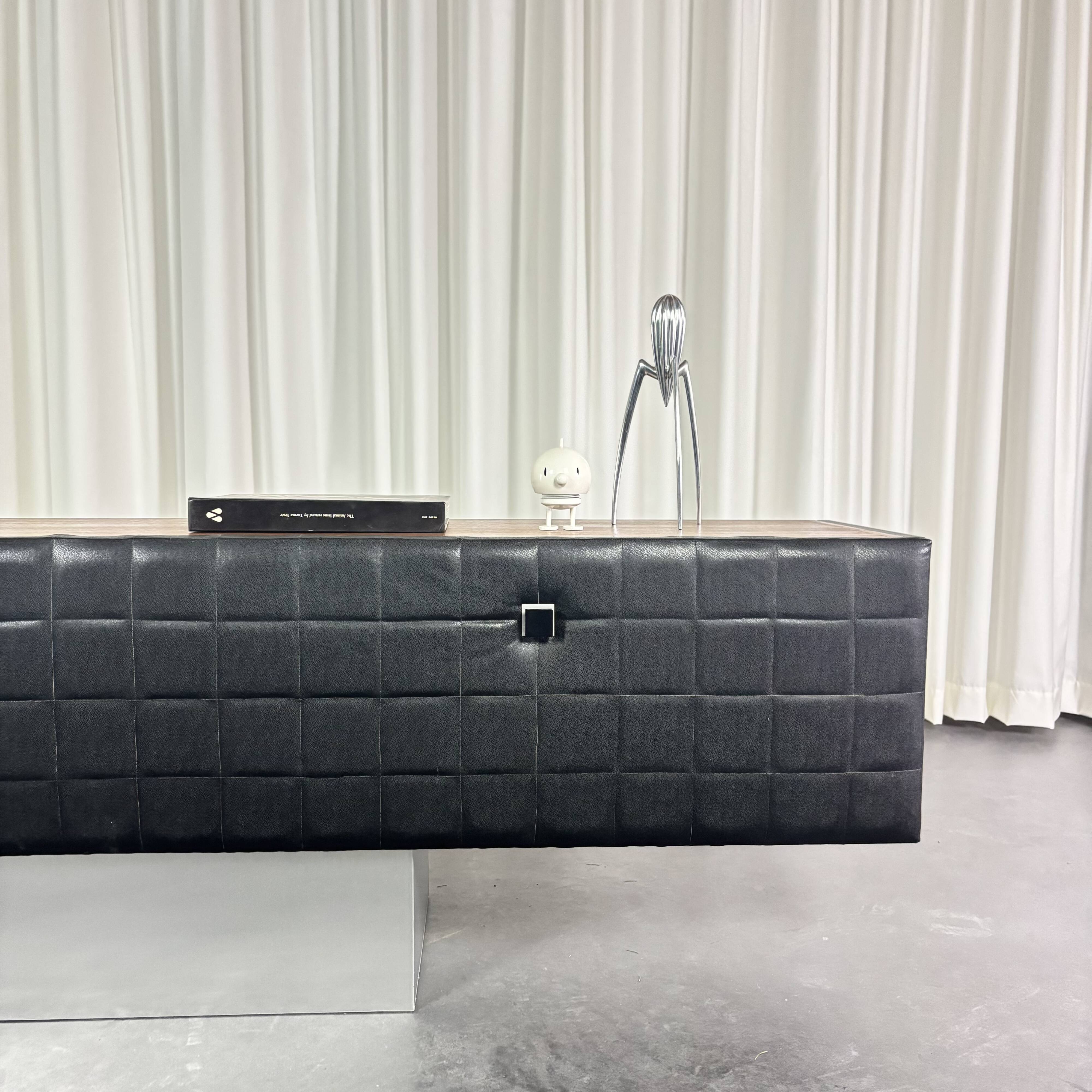 Modernist lowboard, faux leather, wood and stainless steel, 1960.