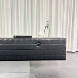 Modernist lowboard, faux leather, wood and stainless steel, 1960.