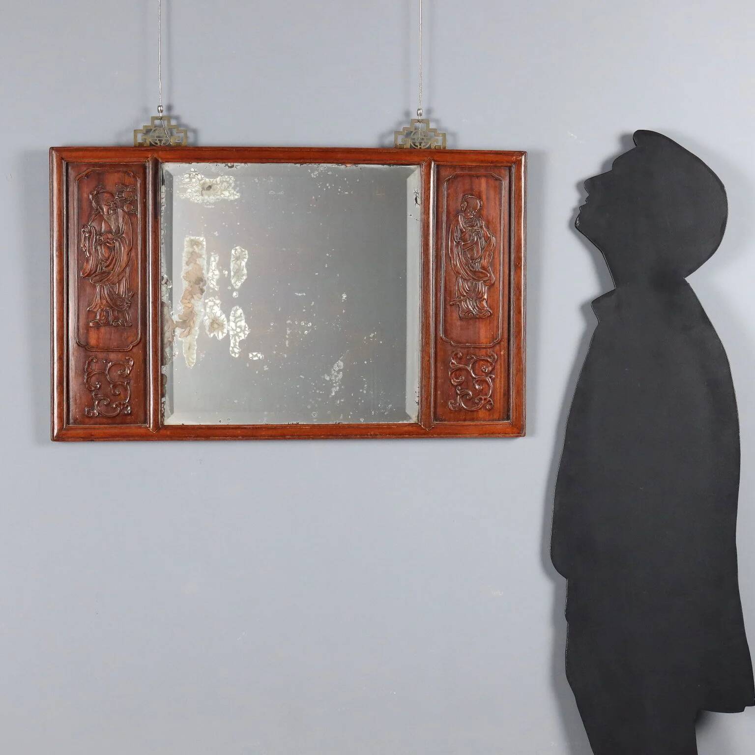 Antique mirror in exotic wood with chinoiserie carvings, 19th century.