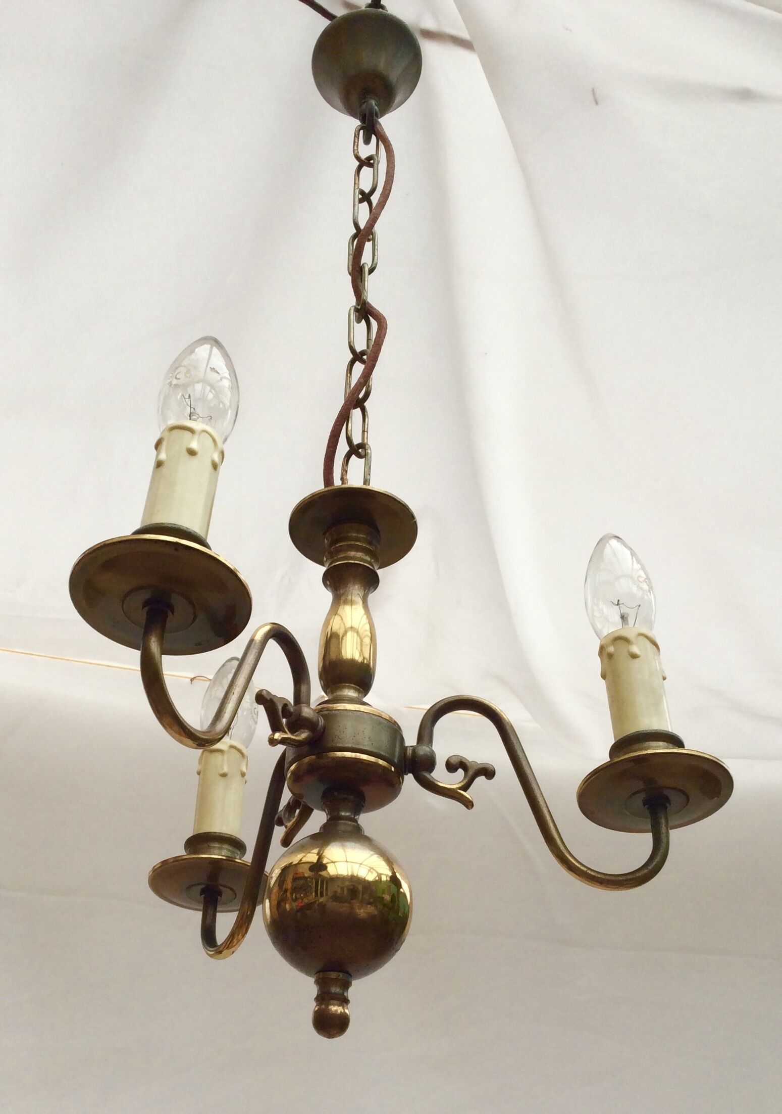 Metal chandelier repainted in copper color with 3 candle-shaped bulbs