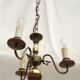 Metal chandelier repainted in copper color with 3 candle-shaped bulbs