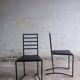 Set of 4 minimalist black steel dining chairs.