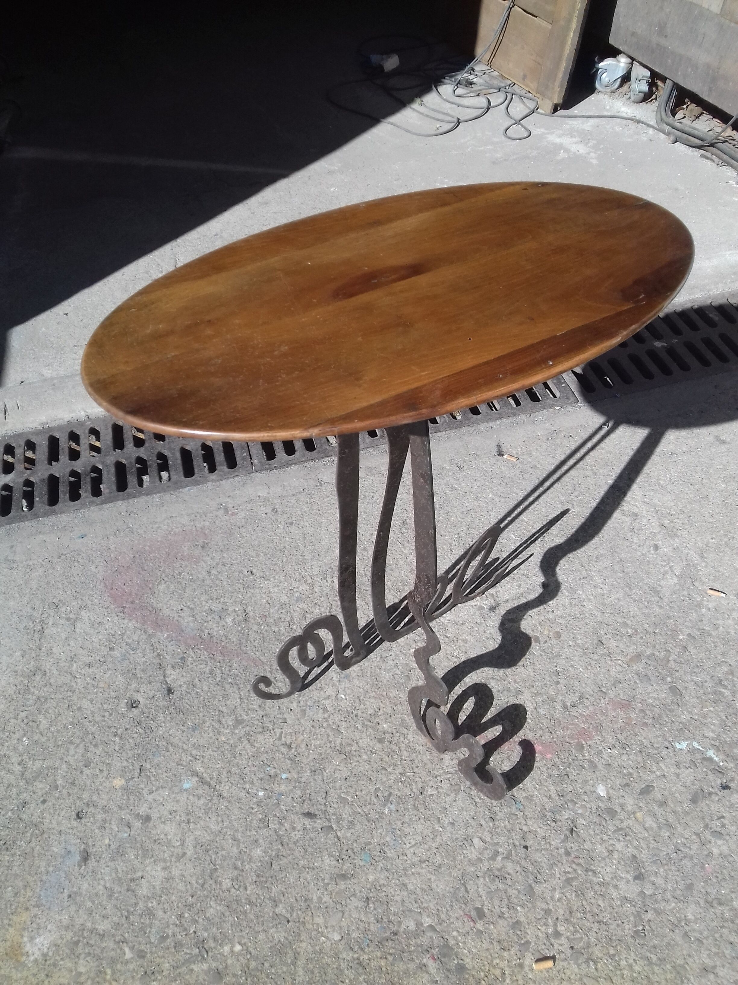 Steel side table with an oval walnut top