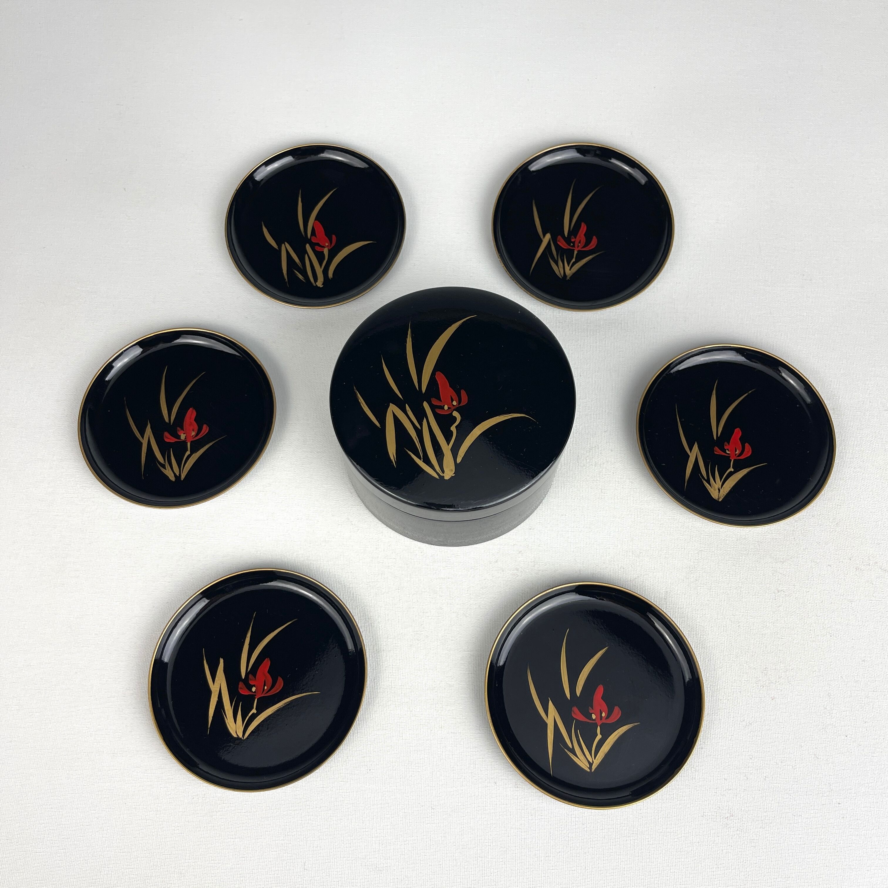 Coasters and their vintage black lacquered wooden box